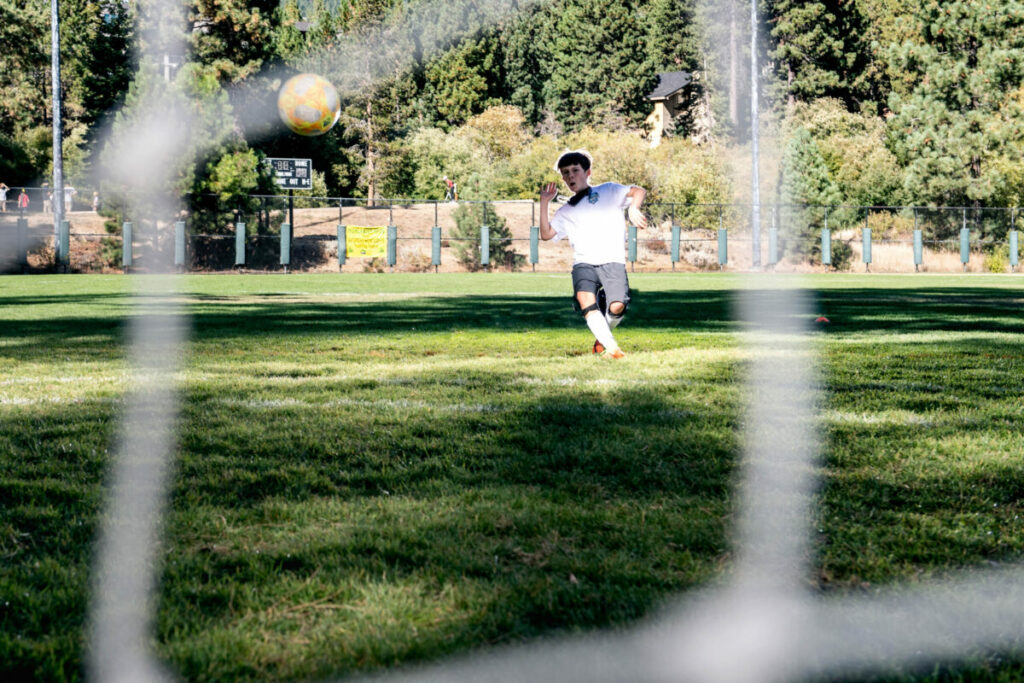 soccer field and one player kicking a ball