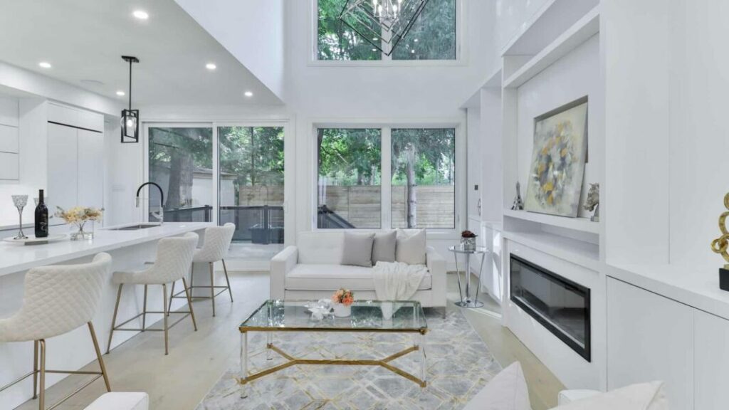 white room with white furniture and glass table